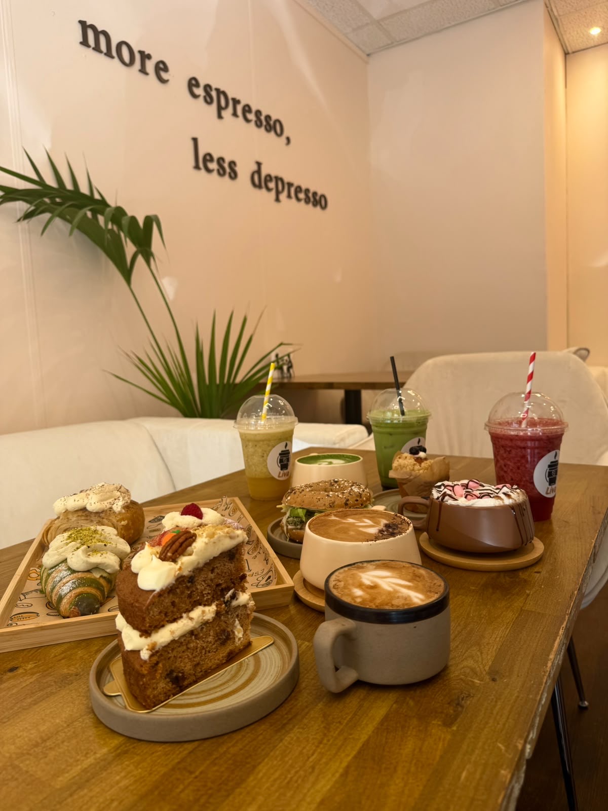 A table at Liva Café laid with coffees, smoothies and cakes